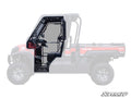 Side profile of a Kawasaki 4x4 with Kawasaki Mule Pro Cab Enclosure Doors highlighted in black, detailing door structure and hardware. The rest of the vehicle is faded, with the SuperATV logo in the bottom right corner.