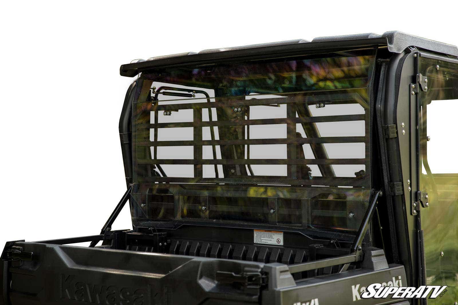 A Kawasaki Mule Pro Rear Windshield made of clear polycarbonate with a horizontal slat design is mounted on a black Kawasaki utility vehicle, separating the driver’s cab from the cargo bed. SuperATV branding appears in the bottom right corner.