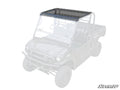 The Kawasaki Mule Pro Tinted Roof is shown installed on a partially transparent UTV, covering the cab above the front seats. The rest of the vehicle is faded to highlight the roof’s protective design.