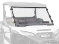 A Kawasaki Ridge Vented Full Windshield with two vents and black clamps is installed on a white Kawasaki utility vehicle. The background and vehicle are faded to highlight the windshield, with the SuperATV logo in the bottom right corner.