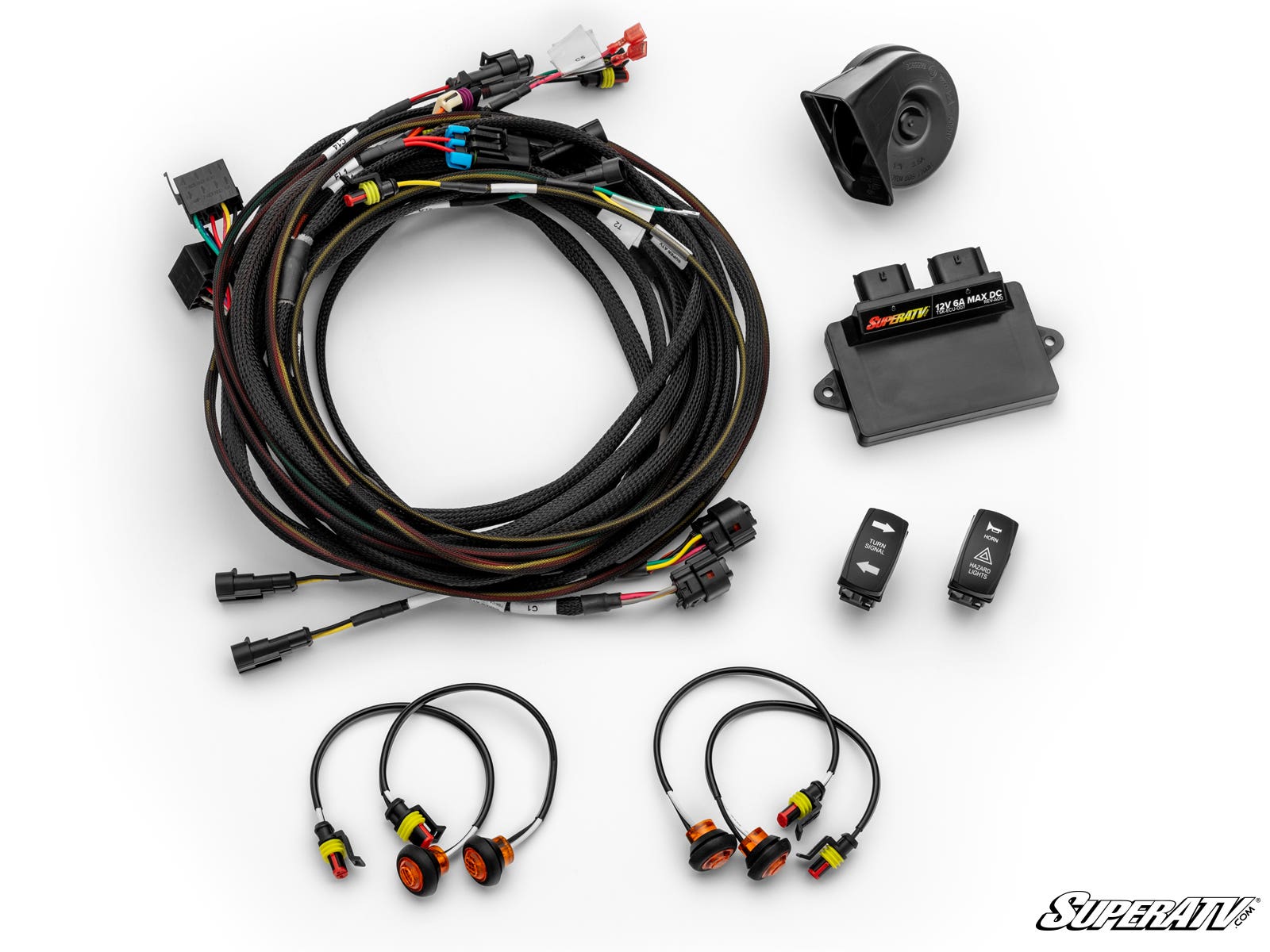 The Kawasaki Teryx 4 Deluxe Self-Canceling Turn Signal Kit includes bundled cables, switches, three round LED indicators, a relay box, connectors, and a black horn arranged on a white background with the SuperATV logo bottom right.
