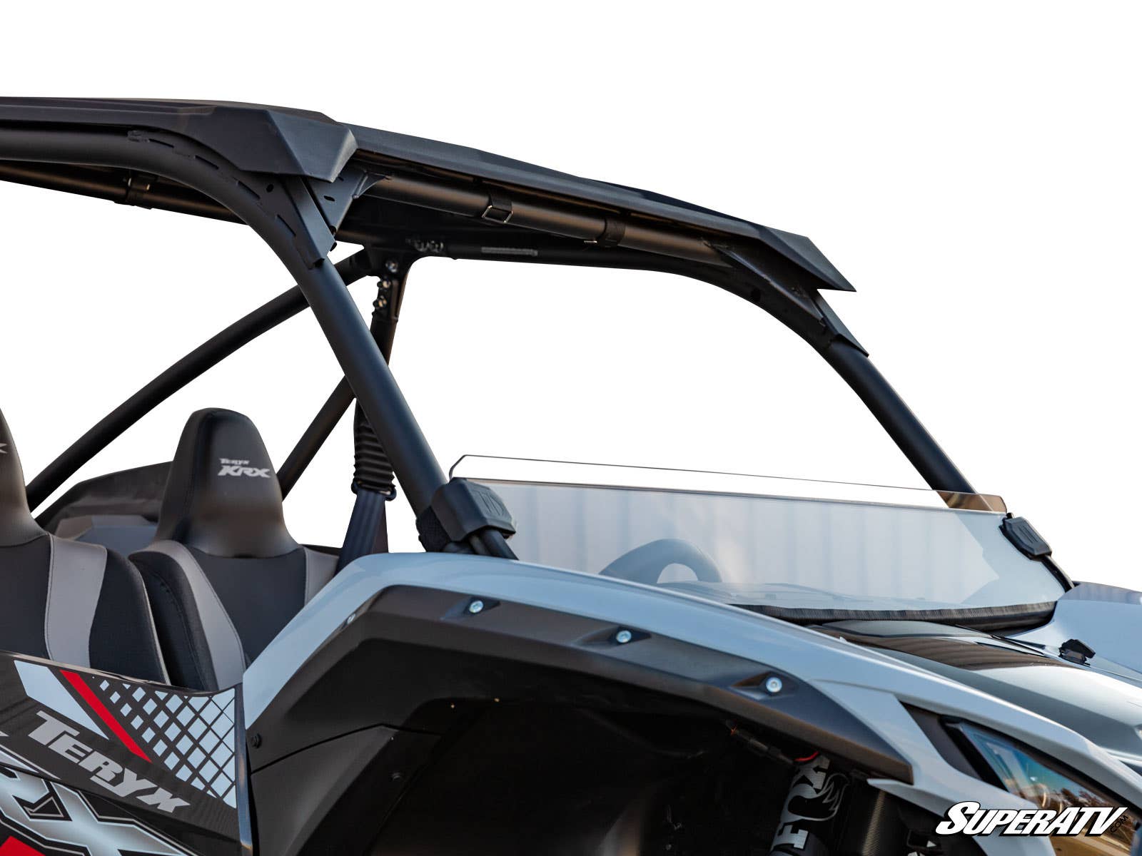 A close-up of a Kawasaki Teryx KRX 1000 featuring a half windshield and roll cage, two seats, “Teryx” branding on the side, set against a white background with the SuperATV logo in the lower right corner.