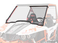 A Kayo S200 Scratch-Resistant Full Windshield with a black frame is installed on a white and orange Kayo S200 side-by-side, showing two branded seats behind it. The SuperATV logo appears in the lower right corner.