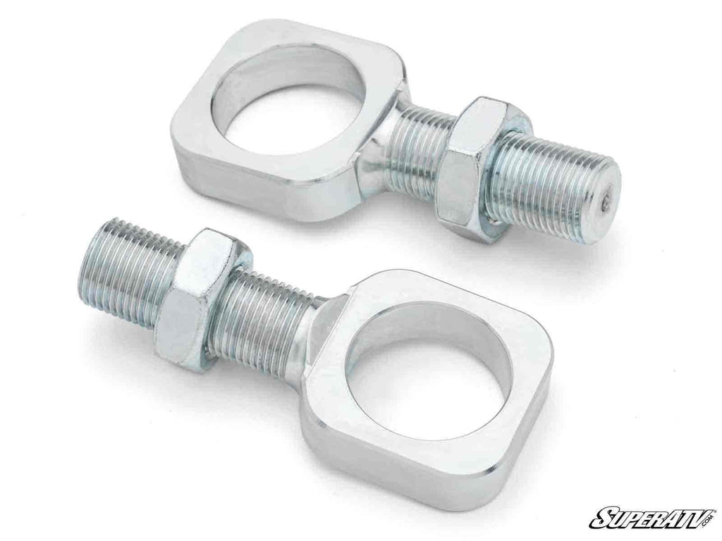 Two Can-Am Heim to Mega Ball Joint Adapters with threaded shafts and hex nuts are shown. The adapters are rectangular with central holes, bolts attached, and have a shiny silver finish. “SuperATV” logo appears in the bottom right corner.