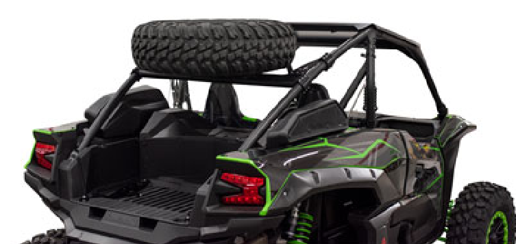 A Teryx KRX 1000 equipped with the Tusk Spare Tire Carrier, seen from the rear, displays off-road tires, a roof-mounted spare, open seating, roll bars, LED tail lights, and no roof or doors visible.