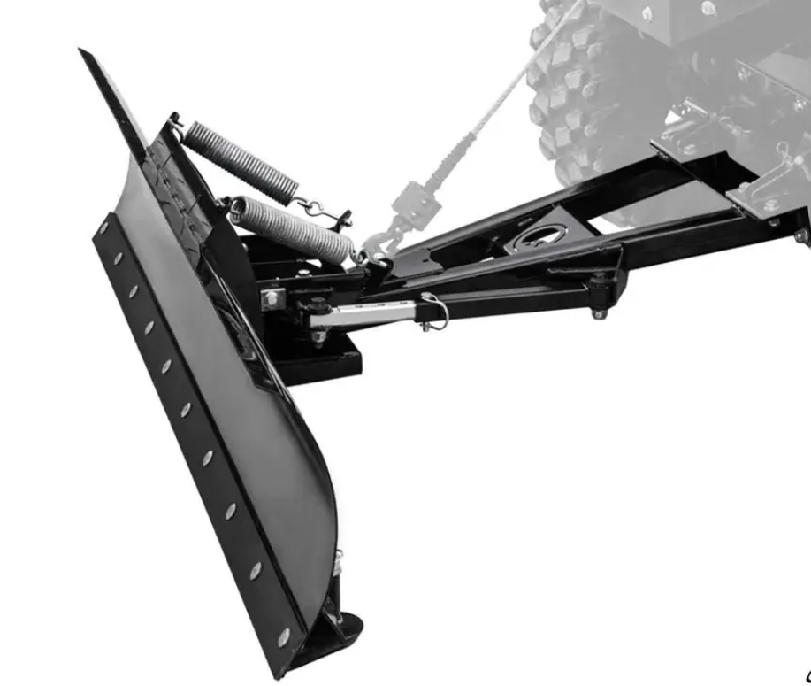 A Kawasaki Teryx Plow Pro Snow Plow, with a black metal blade, coil springs, mounting frame, and hydraulic cylinder for lift and angle adjustment, is attached to a vehicle’s front. A large tire and winch cable are visible in the background.