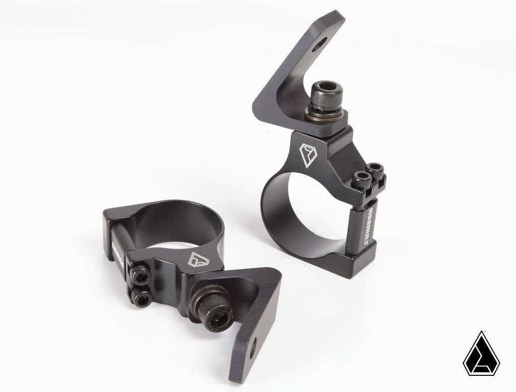 Shown on a white background are two Assault Industries 55deg Top Tube Light Bar Mount Brackets, set of 2, featuring black metal construction with angular design, bolt fastenings, circular openings, and a small triangular logo for mounting lights.