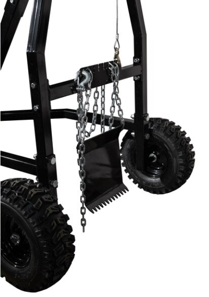 Close-up of the Log Haulers heavy-duty black metal frame with large rugged wheels. A metal chain suspends a black rectangular plate with serrated edges, highlighting the haulers sturdy build for demanding mechanical tasks.
