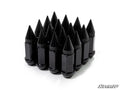 Sixteen glossy black Spiked Lug Nuts, each with a pointed top and faceted sides, are arranged in a tight triangular formation on a white background. The SuperATV logo appears in the bottom right corner.