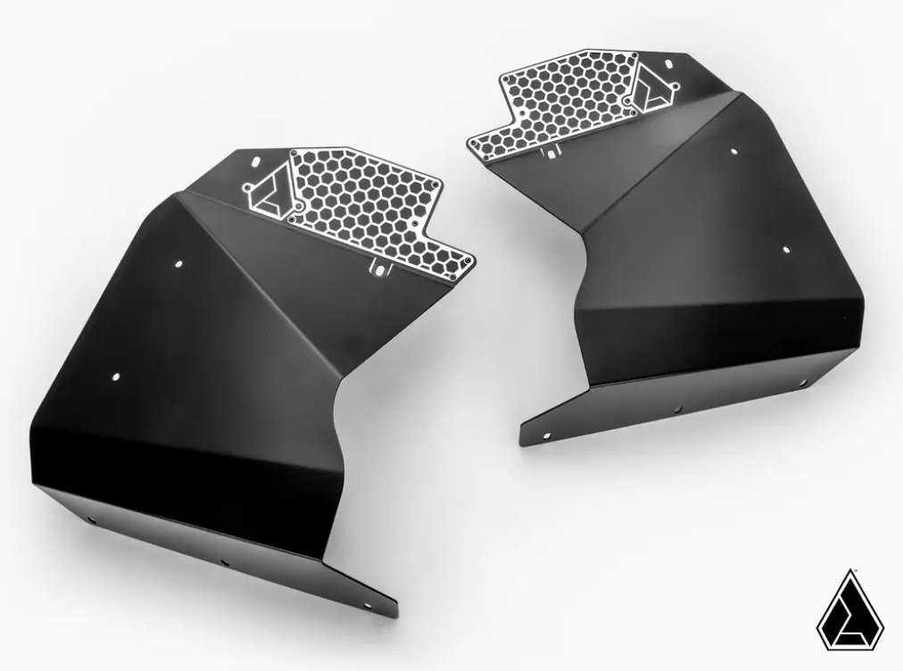 Two Can-Am Maverick R Inner Fender Guards are shown facing each other on a white background. Made of black metal, each features multiple screw holes, a perforated silver honeycomb edge, and a small geometric logo at the lower right.