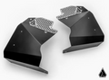 Two Can-Am Maverick R Inner Fender Guards are shown facing each other on a white background. Made of black metal, each features multiple screw holes, a perforated silver honeycomb edge, and a small geometric logo at the lower right.