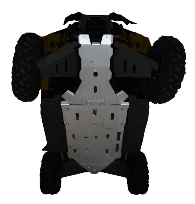 The image shows a 2015-2018 Maverick Xds Full Belly Skid Plate Set installed, covering most of the ATV’s undercarriage to protect it from debris. Four rugged tires are visible at each corner.