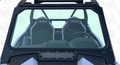 Close-up of the Glass Windshield with Vent for Polaris RZR Trail S, showing two black “RZR” seats, roll cage, steering wheel, and dashboard clearly visible through the windshield.