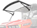 A Gravely Atlas JSV MaxDrive Power Flip Windshield with two black wiper arms is installed on a red off-road utility vehicle featuring two seats, roll cage bars, and an ATLAS JSV logo on the hood. The SuperATV logo appears in the bottom right corner.