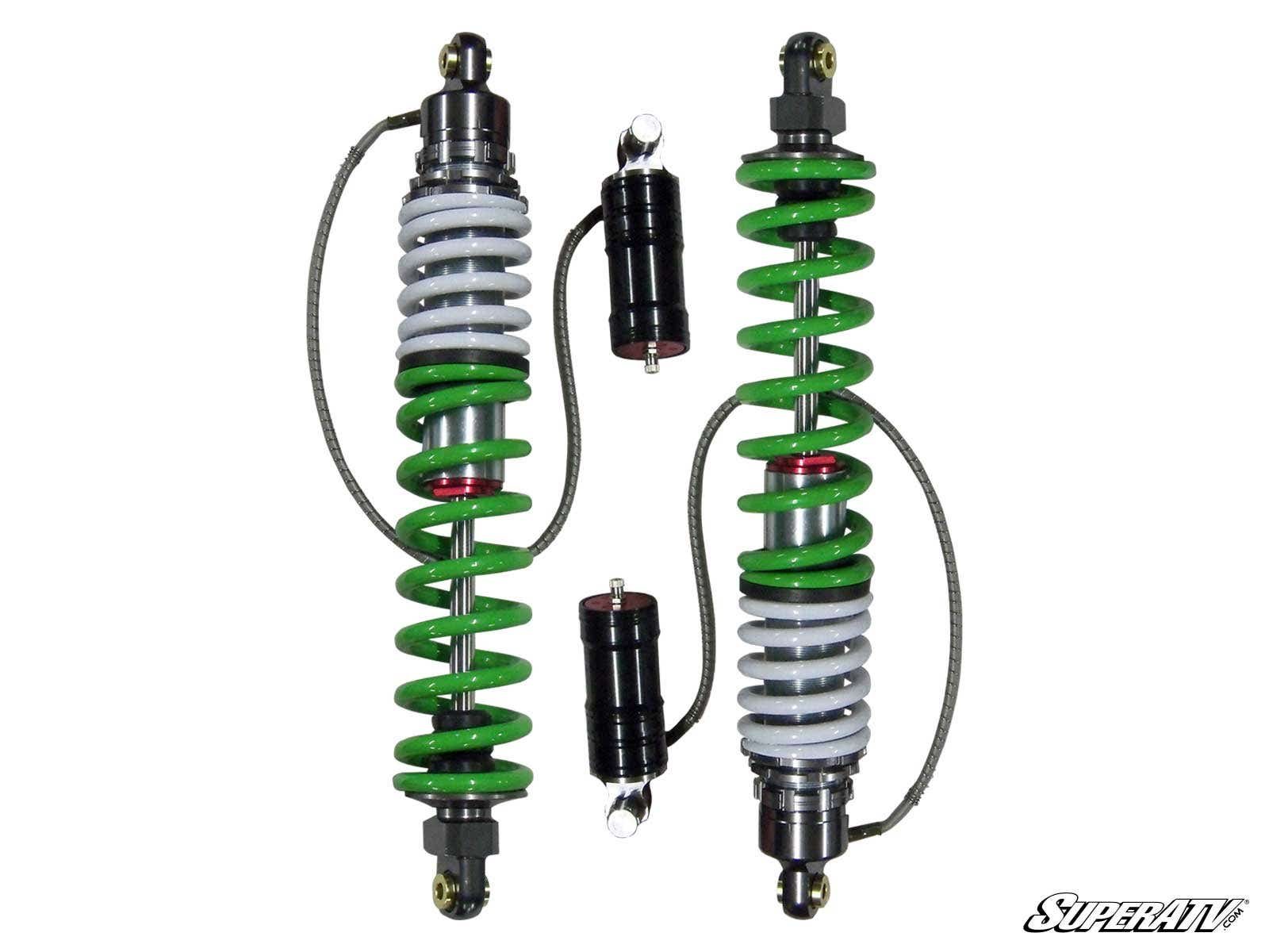 A pair of Phantom Pro Sport Series Remote Reservoir Shocks for RZR S 800 are shown side by side on a white background, featuring green and white coils, black reservoirs, silver springs, attached hoses, and the SuperATV logo in the corner.