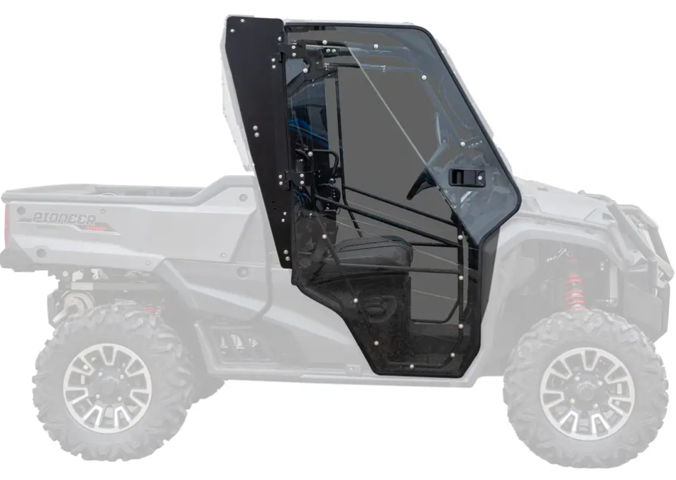 The Honda Pioneer 1000 Scratch Resistant Hard Doors feature a transparent black side door with a metal frame, slanted window, and hinges attached to the cab of a light gray off-road utility vehicle. The rest of the vehicle is faded to highlight the door.