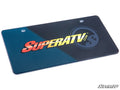 The SuperATV Front Vanity Plate features a dark blue and black diagonal background, bold “SUPERATV.COM” text, a faint circular logo, two top mounting holes, and the SuperATV logo in the bottom right corner.