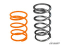 Two upright coiled springs are displayed on a white background. The left spring is shorter, wider, and orange; the right is taller, narrower, and metallic gray. The SuperATV logo appears bottom right. Product: Polaris RZR XP 4 1000 Clutch Kit.