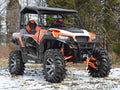A Polaris side-by-side equipped with a Polaris General 3 Lift Kit and large tires is parked on patchy snow. The helmeted driver wears red goggles, leafless trees stand in the background, and the SuperATV logo appears in the corner.