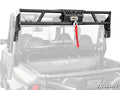 The Polaris General XP 1000 Game Loader Rack is a black metal headache rack with an integrated winch and red strap, mounted on a side-by-side utility vehicle bed. The winch is centered at the top; SuperATV logo appears in the lower right on a white backgr