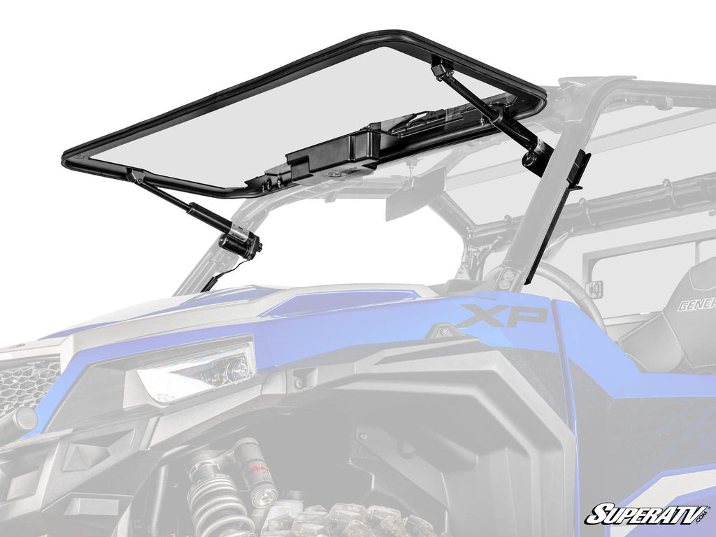 A Polaris General XP 1000 MaxDrive Power Flip Glass Windshield in blue is shown open, supported by black hydraulic struts with a visible frame and hinges. The SuperATV logo is displayed in the bottom right corner.