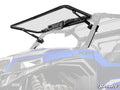 A clear Polaris General 1000 MaxDrive Power Flip Glass Windshield with the SuperATV logo at the bottom right is installed on a blue off-road vehicle, supported by black hydraulic arms and hinges. The headlight and suspension are partially visible.