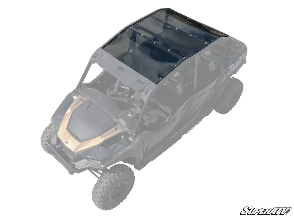 The Polaris General 4 Seater Tinted Roof, made from black-tinted polycarbonate, is installed on a four-seater off-road vehicle. Its partial transparency accentuates the roof’s fit and coverage, with the SuperATV logo in the bottom right corner.