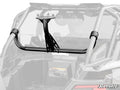 A Polaris RZR PRO XP Spare Tire Carrier, finished in black metal, is mounted horizontally on the rear roll cage of an off-road vehicle. The partially transparent background vehicle highlights the carriers attachment and structure.