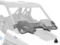 The Assault Industries Polaris RZR Turbo R Half Windshield, featuring two foldable tinted sections and a triangular logo in the bottom left corner, is installed on the front of a side-by-side off-road vehicle with the rest of the vehicle partially faded o