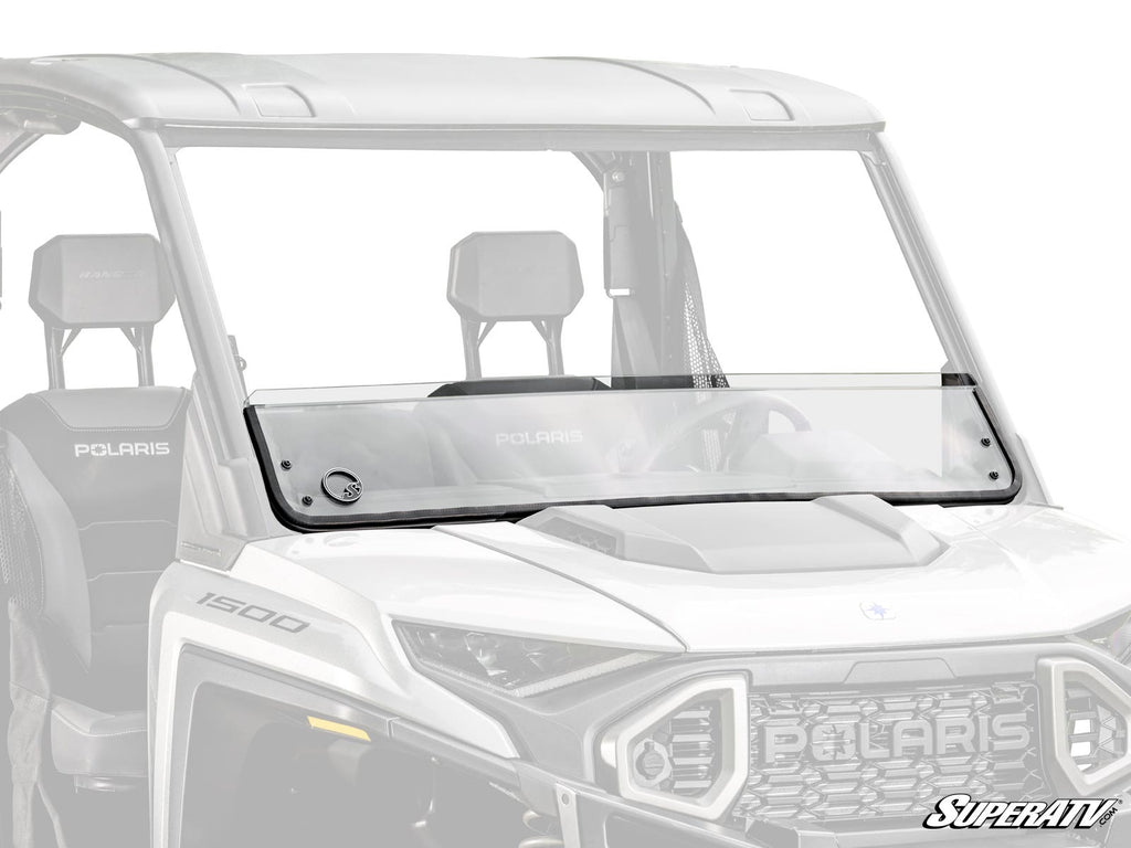 A Polaris Ranger XD 1500 Half Windshield with a horizontal seam, rubber seal, and a circular left-side vent is mounted on a white utility vehicle. The clear glass covers the front; the background and interior are faintly visible.