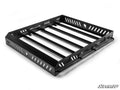 The Gravely Atlas JSV 6400 Outfitter Roof Rack is a sturdy, rectangular black metal rack with ventilation slots, four crossbars, raised sides for cargo security, a tubular front guard, mounting holes, and white branding.