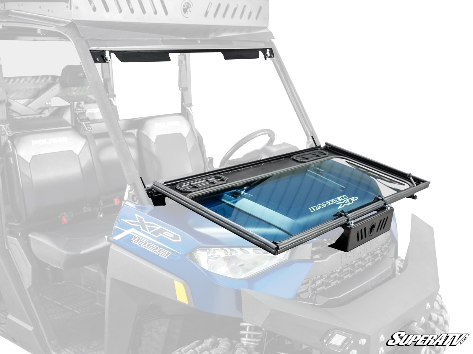 A Polaris Ranger XP 1000 with a blue body features a SuperATV Flip Down Glass Windshield, framed in black with a vent, partially open. The SuperATV logo appears in the lower right corner and the seats are visible behind the glass.