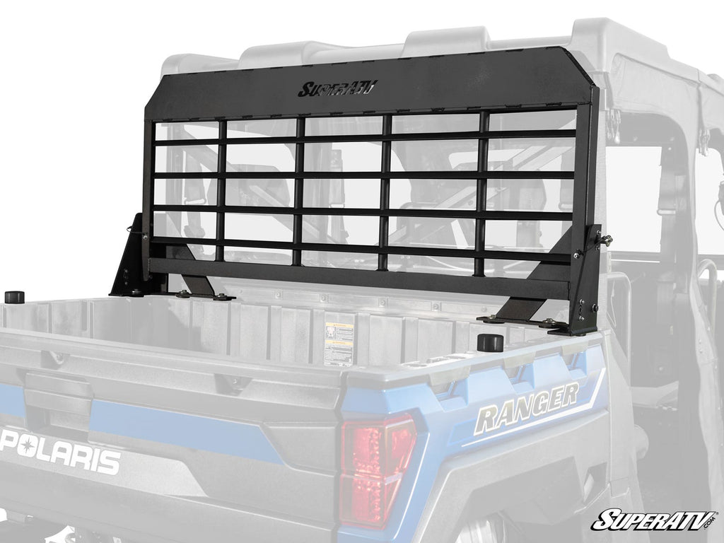 A Polaris Ranger XP Kinetic Headache Cargo Rack with horizontal black metal bars is installed behind the cab in the cargo bed of a blue Polaris Ranger, providing rear window protection. SuperATV and Polaris logos are visible.