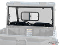 A clear Polaris Ranger Midsize Rear Sliding Windshield with a small rectangular sliding window is installed behind the cab on a gray utility vehicle. The SuperATV logo is shown in the bottom right corner of the image.