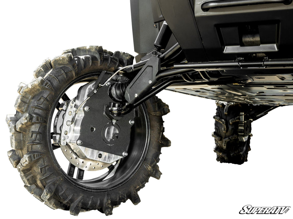 Close-up of a Polaris Ranger XD 1500 fitted with 8 GDP Portals shows its rugged rear suspension and large, thick-treaded tire. Suspension components and undercarriage highlight durability; SuperATV logo appears bottom right. Ground not visible.