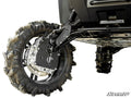 Close-up of a Polaris Ranger XD 1500 fitted with 8 GDP Portals shows its rugged rear suspension and large, thick-treaded tire. Suspension components and undercarriage highlight durability; SuperATV logo appears bottom right. Ground not visible.