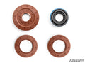 Four circular seals from the Polaris Ranger Transmission Seal Kit are arranged in a square on a white background. Three seals are brown, one is black with a blue inner ring. The SuperATV logo appears in the bottom right corner.