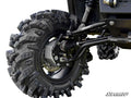 Close-up of a Polaris Ranger XP 900 6 Portal Gear Lift showing a large off-road tire with deep treads on a black wheel, plus visible suspension components—shock absorbers, control arms, and brake disc. The SuperATV logo appears in the bottom right corner.