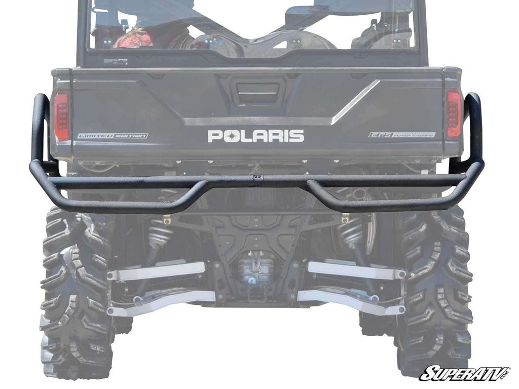 Rear view of a black Polaris Ranger XP 1000 with large rugged tires, suspension, and a matte black Rear Extreme Bumper With Side Bed Guards by SuperATV for added protection and utility along the cargo areas back.