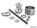 The Polaris Wheel Bearing Removal Tool set includes silver-colored metal parts—a threaded rod, two hex nuts, two washers, a spacer, a domed cap, a spool-shaped piece, a rubber O-ring, and a SuperATV-branded cylinder—displayed on a white background.