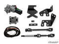 The Polaris Ranger XP Kinetic Power Steering Kit includes a motor, black metal brackets, two black U-joint steering shafts, wiring harness, and a small control unit. The SuperATV logo appears in the lower right corner on a white background.