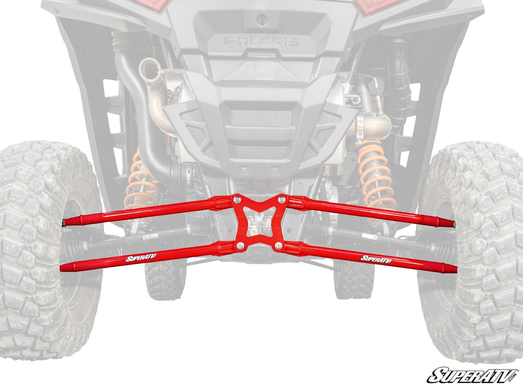 A pair of bright red Polaris RZR XP Radius Arms installed on the rear suspension of an off-road vehicle, with the rest of the vehicle faded to highlight the arms. Large tires, shocks, exhaust, and a SuperATV logo are visible.