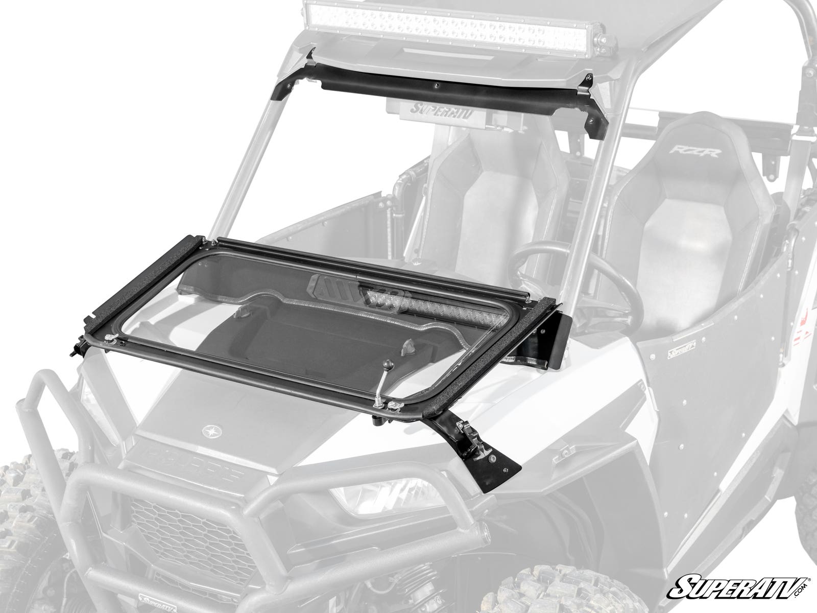 A Polaris RZR S 1000 Flip Down Glass Windshield with a black frame is mounted on an off-road vehicle. The transparent windshield is partially open, revealing its hinges and hardware, with the SuperATV logo at the bottom right.