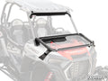 A Polaris RZR XP 1000 with white and red body, black seats, Turbo and Polaris labels features a SuperATV-branded Flip Down Glass Windshield that is clear, foldable, black-framed, hinged at the bottom, and shown partially open.