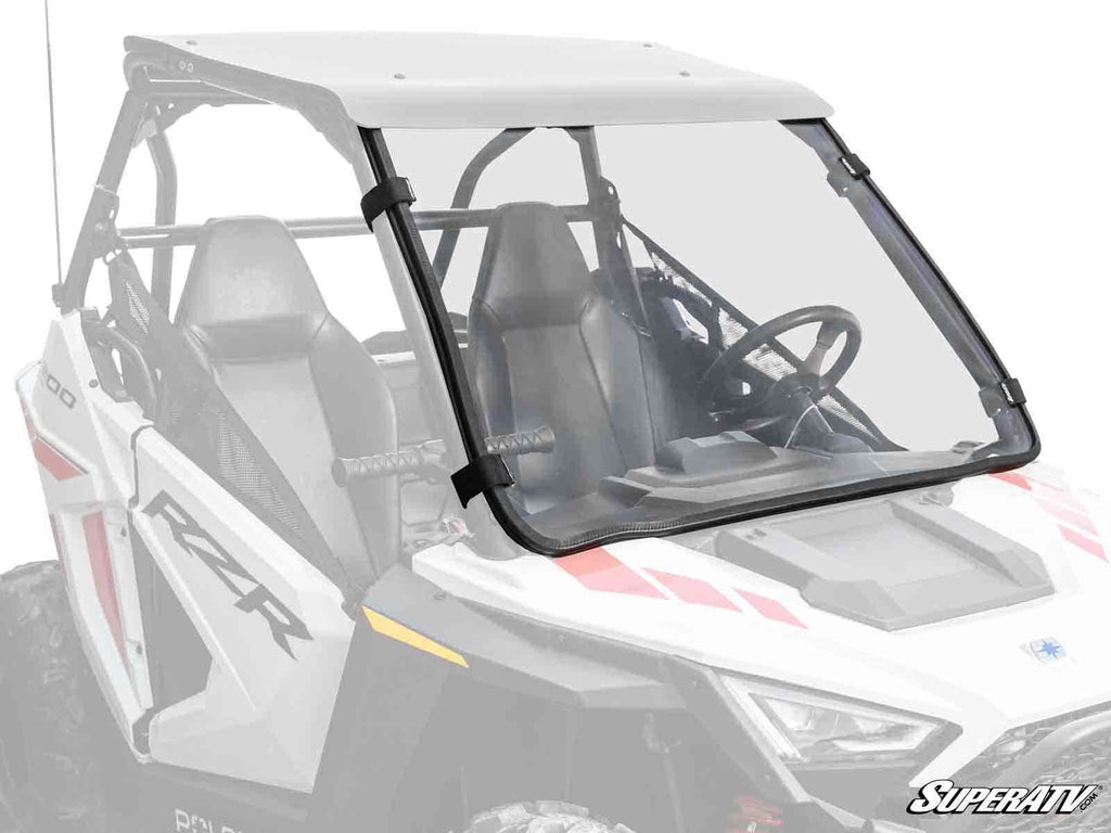 A white Polaris RZR with two bucket seats, a roof, and a visible steering wheel features the Polaris RZR 200 Full Windshield. The clear windshield covers the front and is secured on both sides with black clamps.