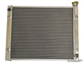 The Polaris RZR 900 Heavy-Duty Radiator is a rectangular aluminum unit with horizontal cooling fins, left-side inlet/outlet ports, a yellow radiator cap on the top right, and a white SuperATV logo at the bottom right corner.
