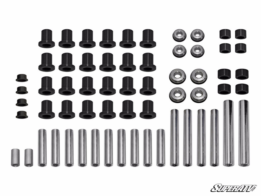A set of Polaris RZR S 1000 A-Arm Bushings, including metal rods, bushings, washers, and spacers arranged in rows on a white background. Most parts are cylindrical with different sizes. The SuperATV logo is in the bottom right corner.
