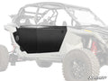 A Polaris RZR Turbo R 4 with light gray body features black metal Aluminum Doors installed on the side. The vehicle displays rugged tires, red suspension coils, and the SuperATV logo in the bottom right corner.