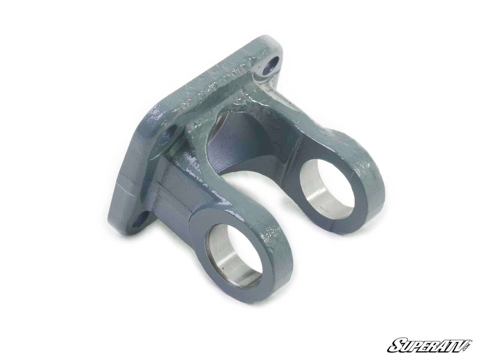The Polaris Prop Shaft Replacement Yoke is a metal bracket with a flat base and two rounded, parallel arms, each featuring a circular opening. It has a smooth, glossy gray finish with the SuperATV logo in the bottom right corner.