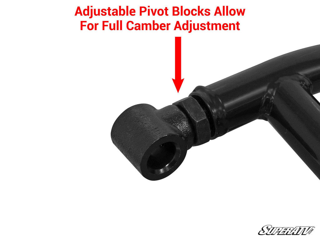 Close-up of a metal pivot block on a black Polaris General High-Clearance A-Arm. A large red arrow points to the adjustable pivot block, with text above: Adjustable Pivot Blocks Allow Full Camber Adjustment. SuperATV logo shown bottom right.